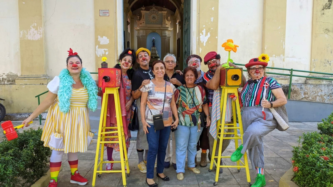 Os Palhaços Trovadores em frente a uma igreja durante o Circular